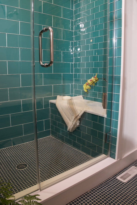Modwalls Lush Glass Subway Tile | 3x6 in Peacock | Blue | Pictured installed in a shower | Colorful Modern glass tile for bathrooms, showers, kitchen, backsplashes, pools & outdoors.