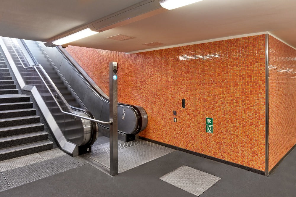 Modwalls Mediterranean Mosaic Porcelain Tile | Valencia Blend Gloss | Orange | Pictured installed in a commercial project on a large wall at a transit center | Colorful Modern & Midcentury tile for bathrooms, kitchens, backsplashes, showers, floors, pools & outdoors.