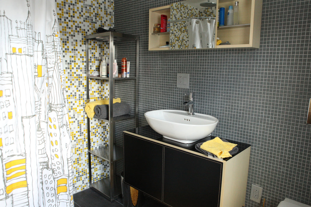 Modwalls Brio Glass Mosaic Tile | Sleet | Gray | Pictured installed in a bathroom | Modern tile for backsplashes, kitchens, bathrooms, showers, pools, and outdoors.