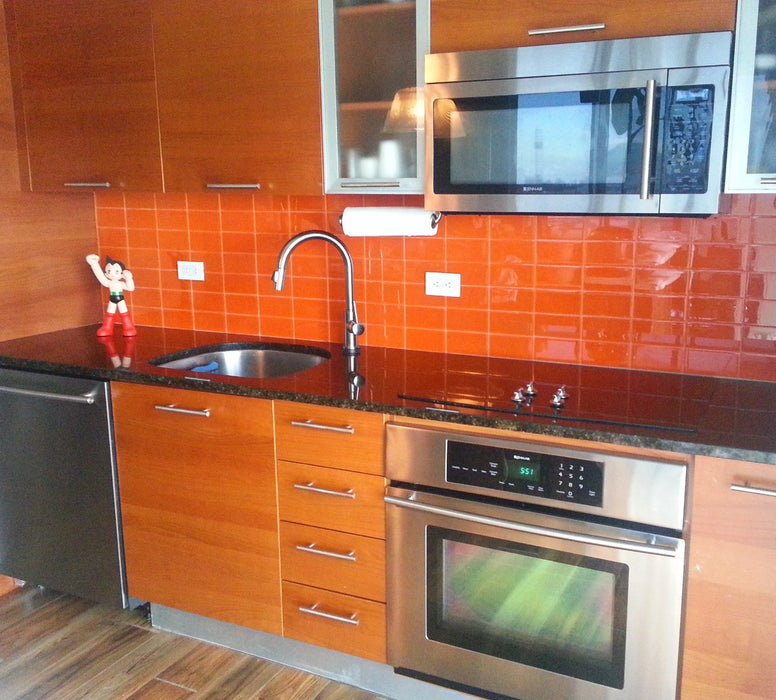 Modwalls Lush Glass Subway Tile | 3x6 in Poppy | Orange | Pictured installed on a kitchen backsplash | Colorful Modern glass tile for bathrooms, showers, kitchen, backsplashes, pools & outdoors.