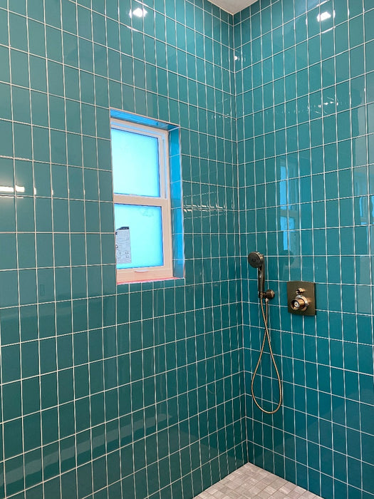 Modwalls Lush Glass Subway Tile | 3x6 in Peacock | Blue | Pictured installed in a shower | Colorful Modern glass tile for bathrooms, showers, kitchen, backsplashes, pools & outdoors.