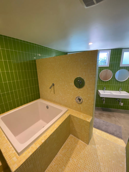 Modwalls Lush Glass Subway Tile | 3x9 in Lemongrass | Green | Pictured installed in a bathroom | Colorful Modern glass tile for bathrooms, showers, kitchen, backsplashes, pools & outdoors.