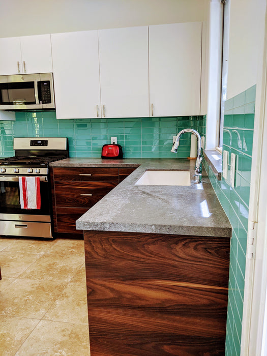 Modwalls Lush Glass Subway Tile | 3x9 in Pool | Blue | Pictured installed on a kitchen backsplash | Colorful Modern glass tile for bathrooms, showers, kitchen, backsplashes, pools & outdoors.