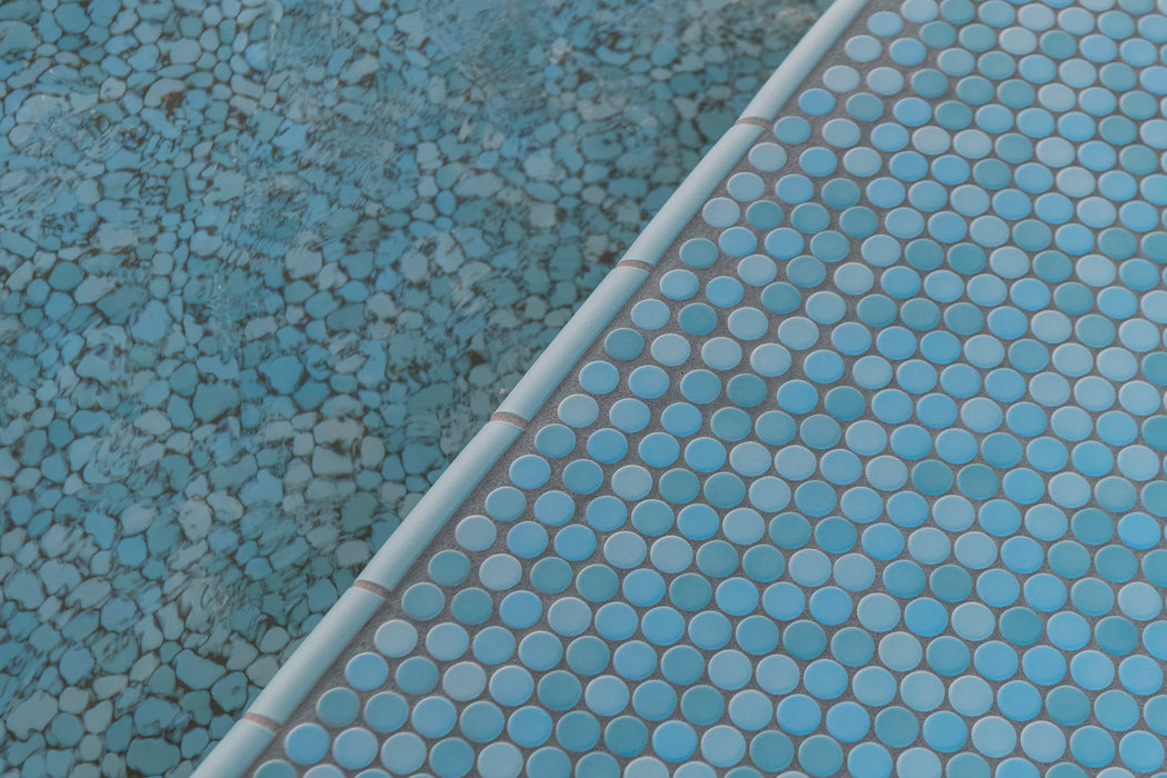 Modwalls PopDotz Porcelain Penny Round Tile | 1” Gloss | Taffy Blend | Blue | Pictured installed in a pool | Colorful Modern & Midcentury tile for bathrooms, kitchens, backsplashes, showers, floors, pools & outdoors.