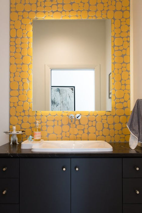 Modwalls Rex Ray Studio Rox Ceramic Tile | Solar | Yellow | Installed on a bathroom vanity wall | Colorful Modern & Midcentury tile for interior walls, bathrooms, kitchens, backsplashes, showers.