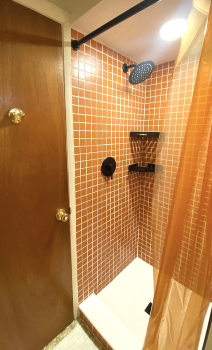 Modwalls ColorBlock 2 Porcelain Tile | Marmalade | Orange | Pictured on the walls of a shower | Colorful Modern & Midcentury tile for bathrooms, kitchens, backsplashes, showers, floors, pools & outdoors. 