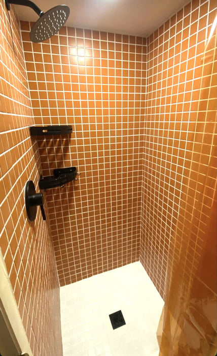 Modwalls ColorBlock 2 Porcelain Tile | Marmalade | Orange | Pictured on the walls of a shower | Colorful Modern & Midcentury tile for bathrooms, kitchens, backsplashes, showers, floors, pools & outdoors. 
