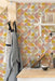 Modwalls ModPaper | ModSpring | Purple, green, blue and pink repeating wallpaper design | Pictured installed in a bakery | Colorful Midcentury and Retro wallpapers for bathrooms, kitchens, living rooms, dining rooms, baby rooms, kid’s rooms, and offices. 