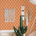 Modwalls ModPaper | ModTwist | Orange and purple oval repeating wallpaper design | Pictured installed in a living room | Colorful Midcentury and Retro wallpapers for bathrooms, kitchens, living rooms, dining rooms, baby rooms, kid’s rooms, and offices. 