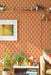 Modwalls ModPaper | ModTwist | Orange and purple oval repeating wallpaper design | Pictured installed in a living room | Colorful Midcentury and Retro wallpapers for bathrooms, kitchens, living rooms, dining rooms, baby rooms, kid’s rooms, and offices. 