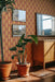 Modwalls ModPaper | ModTwist | Orange and purple oval repeating wallpaper design | Pictured installed in a living room | Colorful Midcentury and Retro wallpapers for bathrooms, kitchens, living rooms, dining rooms, baby rooms, kid’s rooms, and offices. 