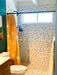 Modwalls Vita Mosaic Porcelain Tile in MCM Blend | Midcentury modern style white, orange, blue and red mosaic tiles | Pictured installed in a shower | Colorful Midcentury and Modern tile for backsplashes, kitchens, bathrooms, showers, floors, outdoor & feature areas. 