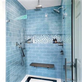 Handmade 3x8 subway tiles in a light blue we like to call hydrangea, installed floor to ceiling in a shower with a custom small hex mosaic inset. This beautiful tile is great for kitchens, backsplashes, bathrooms and showers and is available in 105 unique colors
