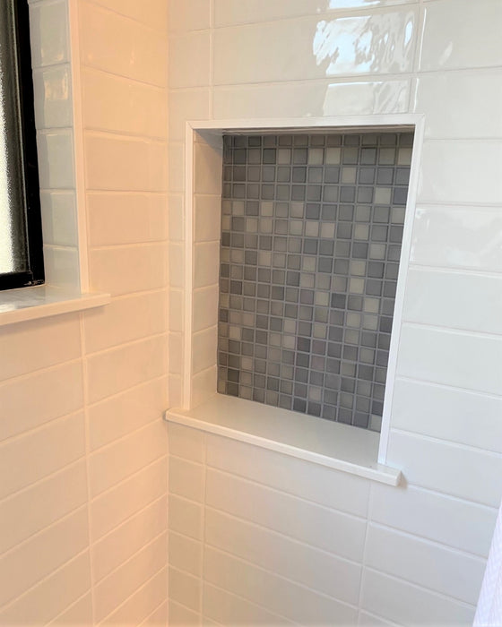 A shower inset with the 1" Meditteranean Mosaic tile in a bright shower set with 3x12 gloss white tiles. The mediterranean tile is a beautiful porcelain tile and great for showers, floors, pools and kitchens